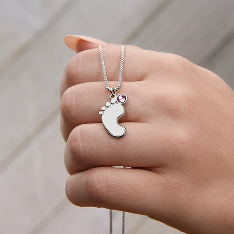 Celebrate the arrival of a newborn or cherish a precious memory with our Custom Baby Feet Necklace with Birthstone. Personalize your gift by engraving a name of your choice onto the pendant and choosing a crystal that correlates with the baby's birth month.