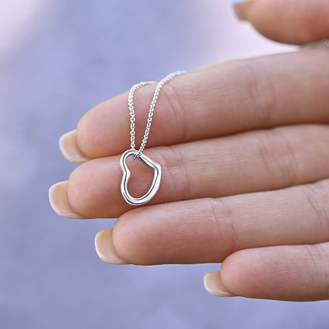 Imagine her delight when she sees this beautiful Delicate Heart Necklace, lovingly crafted in sterling silver and dipped in 14k white gold or 18k yellow gold for added luxury. This piece is pure elegance wrapped up in timeless simplicity. Trends may come and go, but this piece will last a lifetime with its classic subtle beauty.